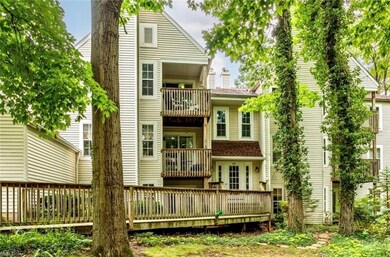 Back of property featuring balcony and a deck