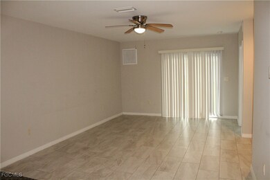 Unfurnished room with a ceiling fan and baseboards
