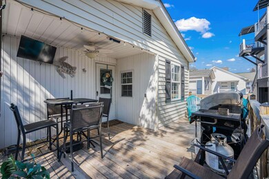 Wooden deck with a ceiling fan and a grill