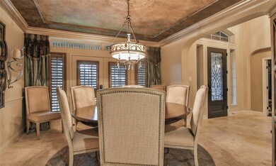 To the right of the entry is the formal dining with coffered ceiling custom painted walls