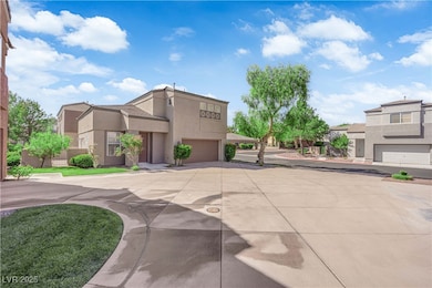 View of front of property with stucco siding, driveway, and a garage