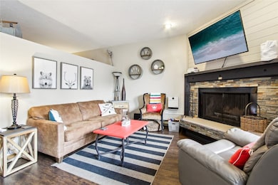Living area featuring wood finished floors, a fire