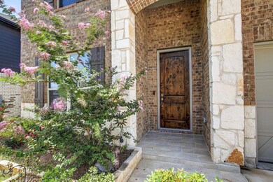 Property entrance with brick siding and stone sid