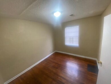 Unfurnished room featuring dark wood-type flooring