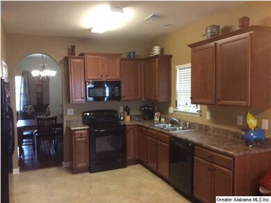 Large, open kitchen with staggered top of cabinets
