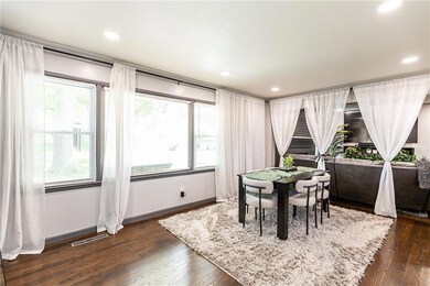 Dining room featuring dark hardwood / wood-style flooring and a wealth of natural light