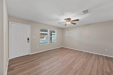Empty room featuring ceiling fan and light hardwood / wood-style floors