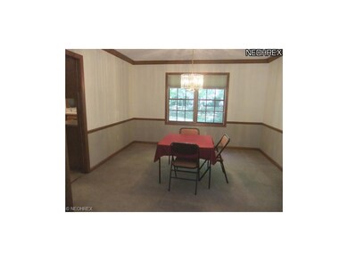 The formal dining room features neutral carpet and