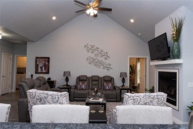 Beautiful vaulted ceiling with ceiling fan - looking from the kitchen.