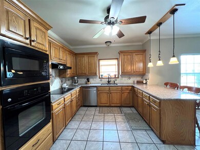 Kitchen with kitchen peninsula, decorative light f