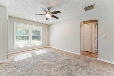 Large living room with plenty of natural light.