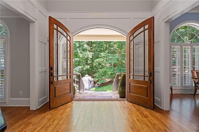 Entrance foyer featuring light wood-type flooring and crown molding