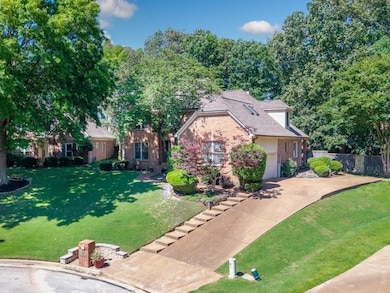 View of front of house with brick siding, driveway, and an attached garage