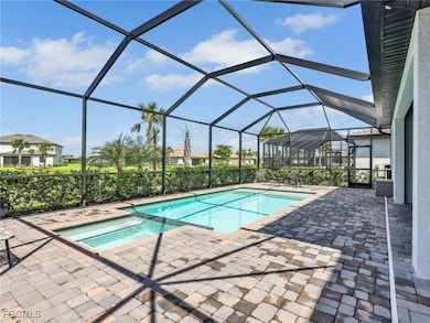 View of swimming pool with a sunroom, a pool with connected hot tub, a lanai, and a patio