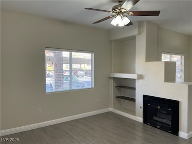 Unfurnished living room featuring wood finished fl