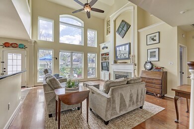 Family room has soaring ceilings with floor to ceiling windows.  Windows come equipped w remote controlled shades.