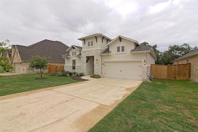 View of front of property with stone siding, driv