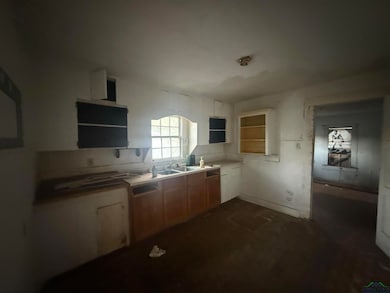 Kitchen with open shelves and light countertops
