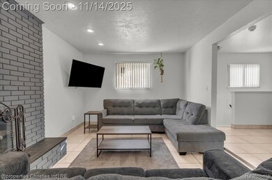 Living area featuring tile patterned floors, a textured ceiling, plenty of natural light, recessed lighting, and a fireplace