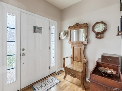 Entry foyer with sidelights and wood floors.