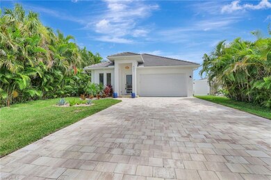 View of front of house with a garage and a front y