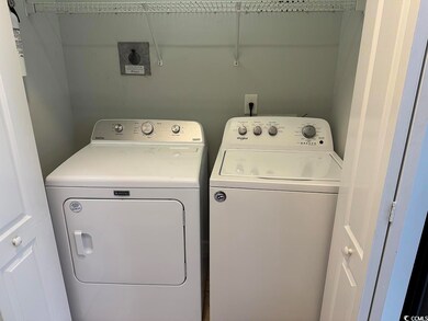 Washroom with washing machine and clothes dryer