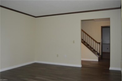 Living room viewing towards foyer and steps leadin