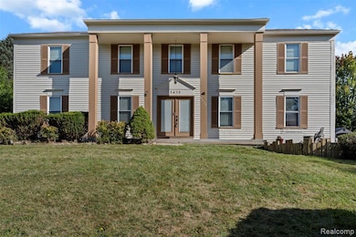 Greek revival inspired property featuring a porch and a front lawn