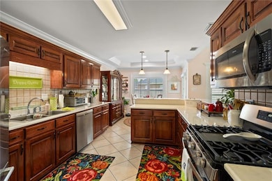 Kitchen with light tile patterned floors, backspla