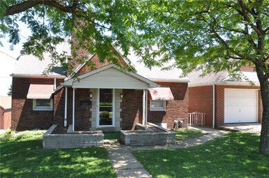 Front of home, with covered porch and mature shade