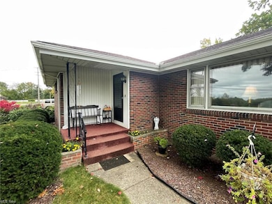 View of exterior entry with a porch
