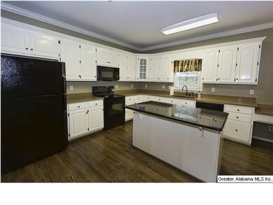 Kitchen with gorgeous countertops, all black appli