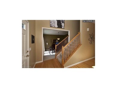 Two story foyer with hardwood flooring