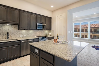 Kitchen with a sink, tasteful backsplash, a kitch