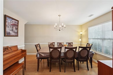 Dining space with visible vents, baseboards, light