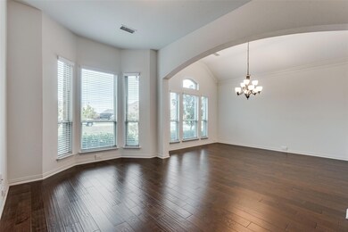 Empty room featuring dark wood-type flooring, a ch