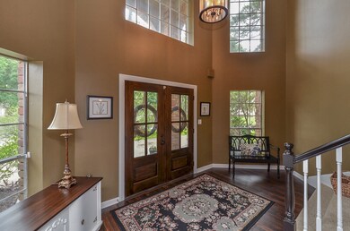 Welcome guests in this beautiful, two-story entry featuring double doors and abundant natural light.
