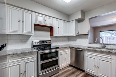 Large kitchen features granite counter tops, stainless steel appliances, under mount sink, pantry and abundant of counter space. and cabinets.