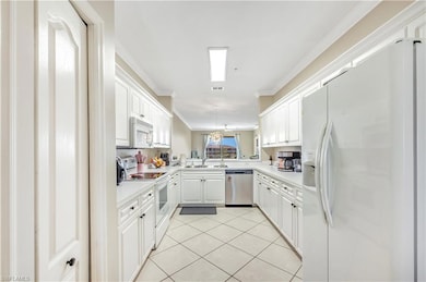 Kitchen with kitchen peninsula, sink, crown moldin