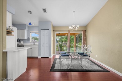 Dining area featuring a chandelier, dark wood-styl