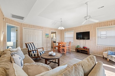 Living room with light hardwood / wood-style floor