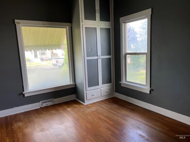 Spare room with baseboards and hardwood / wood-style floors