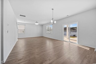 Unfurnished room with wood finished floors and a chandelier