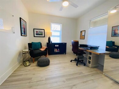 Office space featuring baseboards, a ceiling fan,