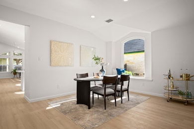 Dining space featuring vaulted ceiling, healthy amount of natural light, light wood-type flooring, and recessed lighting