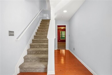 Staircase featuring wood finished floors, baseboards, and recessed lighting