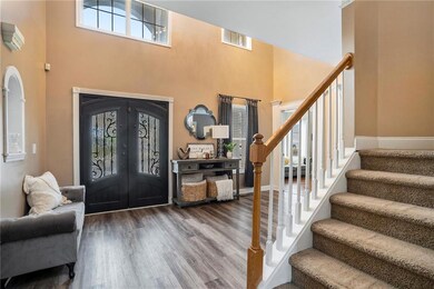 Entrance foyer featuring hardwood / wood-style flo