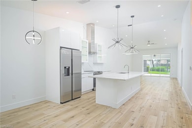 Kitchen with a notable chandelier, a sink, wall ch