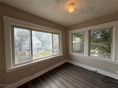 Spare room with dark wood-style floors and a textured ceiling