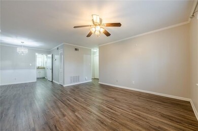 Spare room featuring visible vents, ceiling fan wi